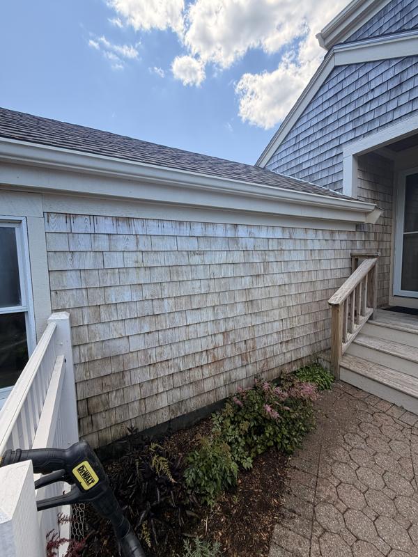 Faded, streaked cedar shingle wall before cleaning