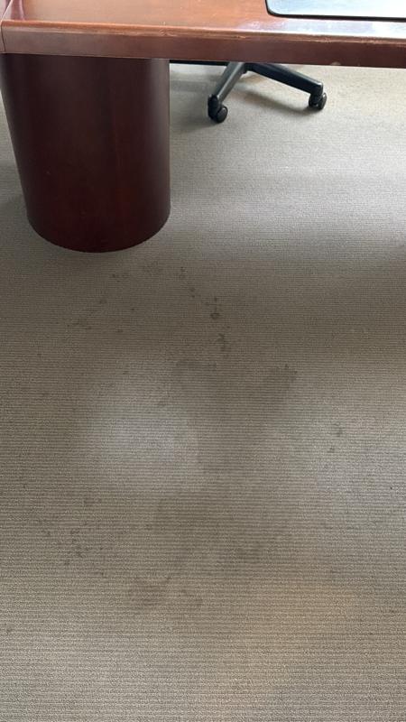 Office carpet with dark spots and stains