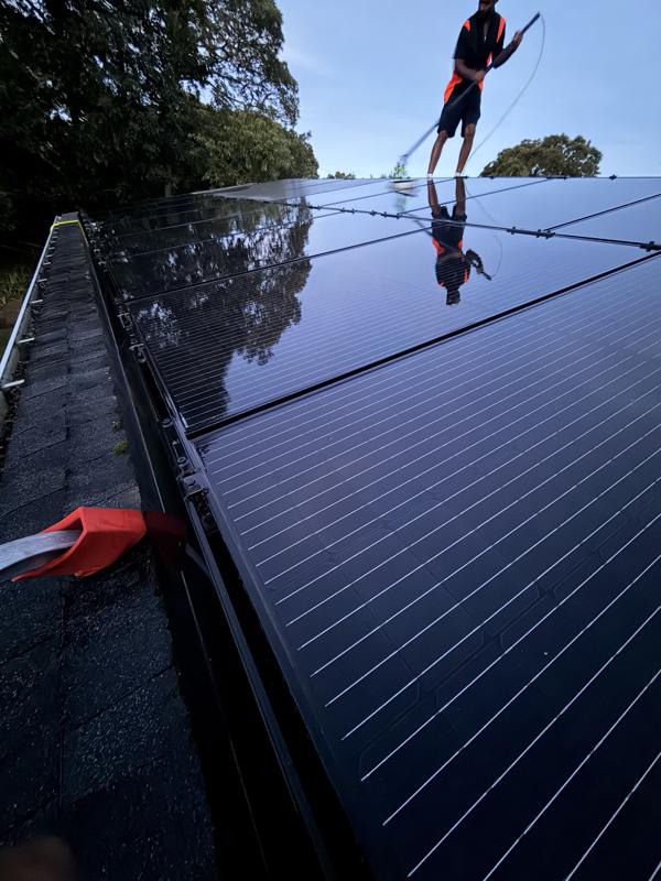 Crew member cleaning solar panels to a mirror finish