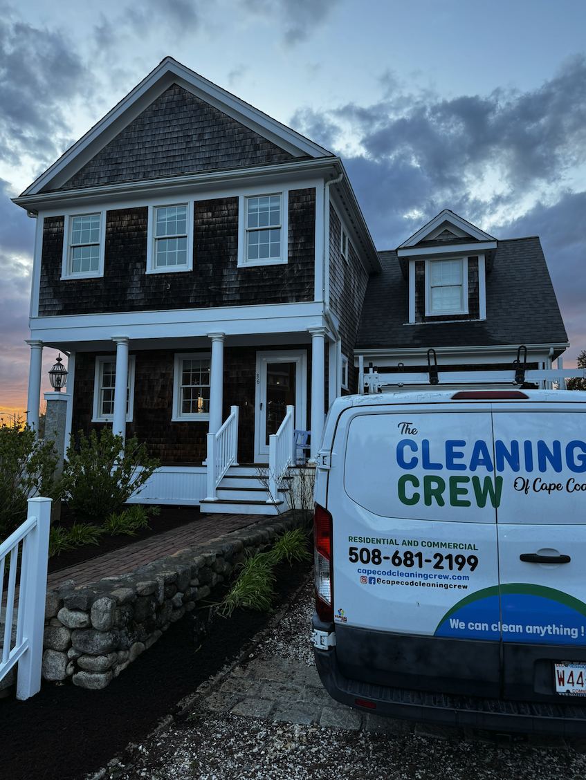 Cedar shingle home at dusk with the crew van in the driveway